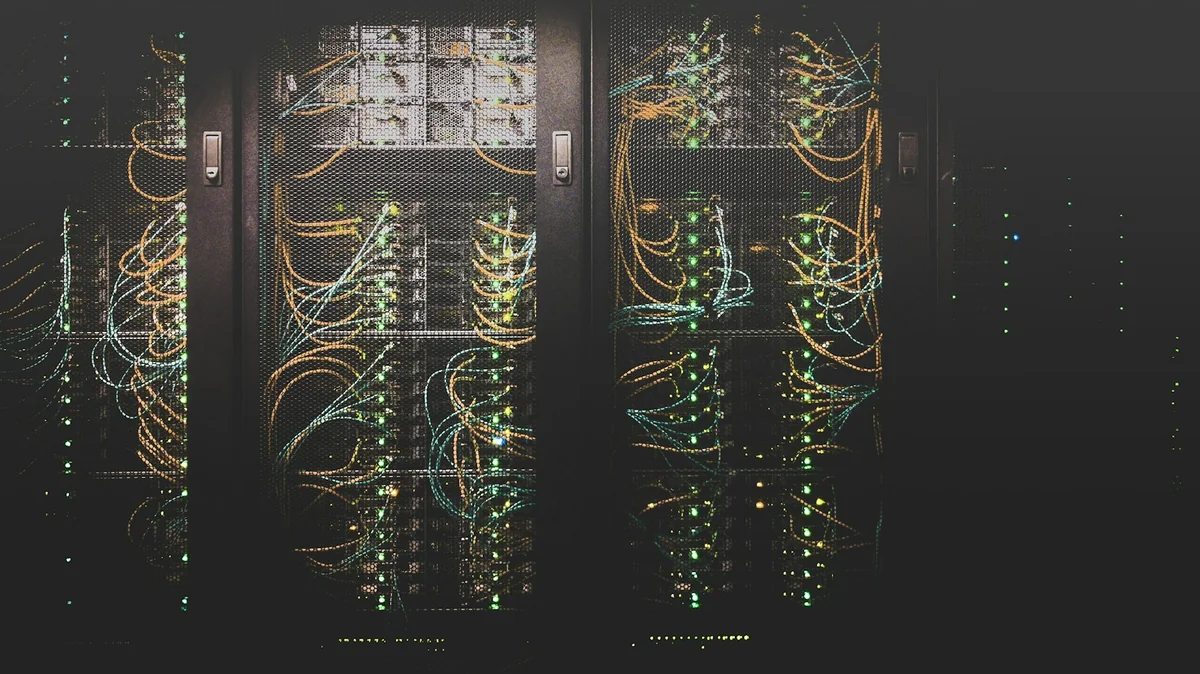 Photograph: Taylor Vick / Unsplash Server racks, network cables, and status lights inside a data center