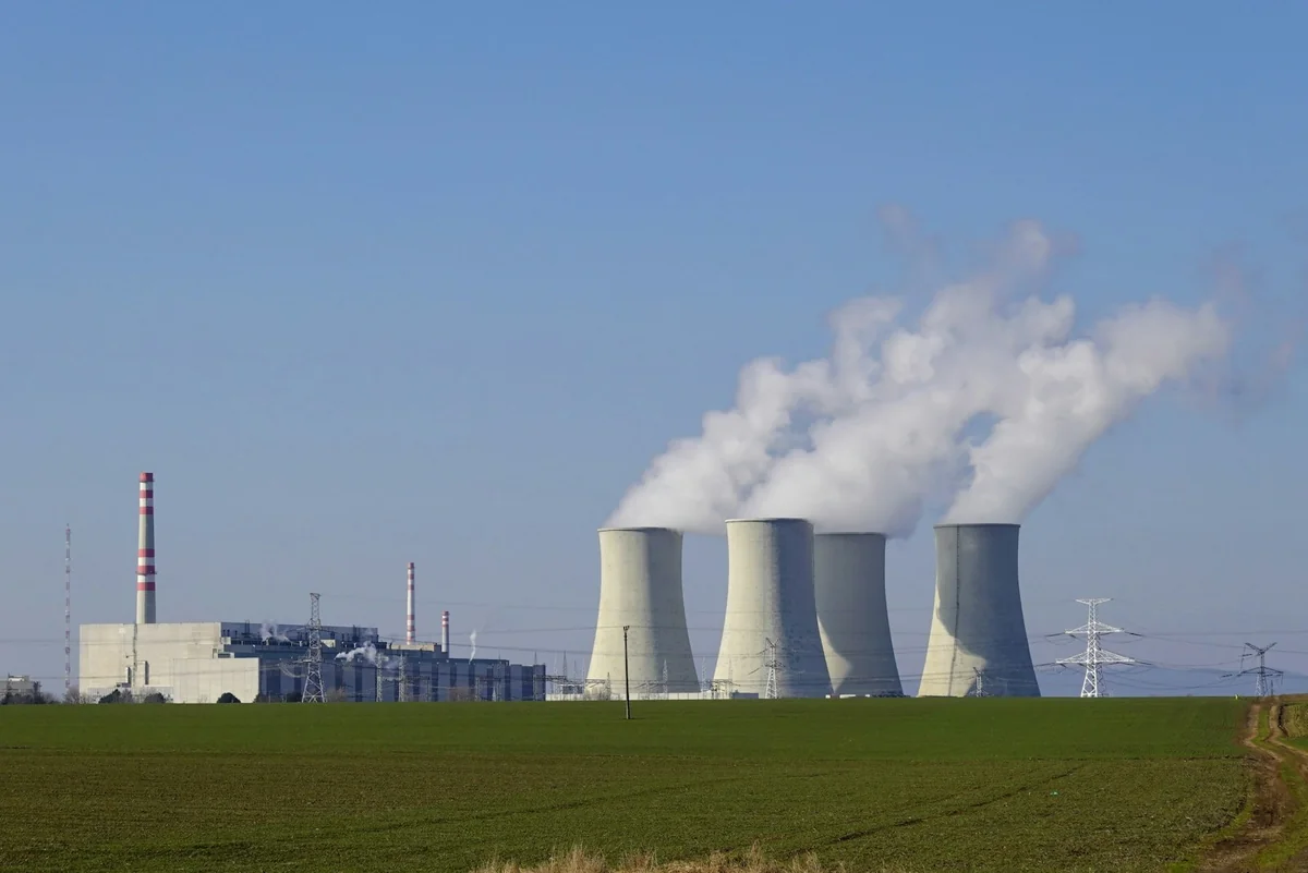 Photograph: Energie-portal.sk / Unsplash Cooling towers and electricity infrastructure at a nuclear power plant